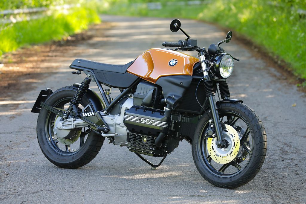BMW K100 SE Roadster bike parked on a scenic road surrounded by greenery.