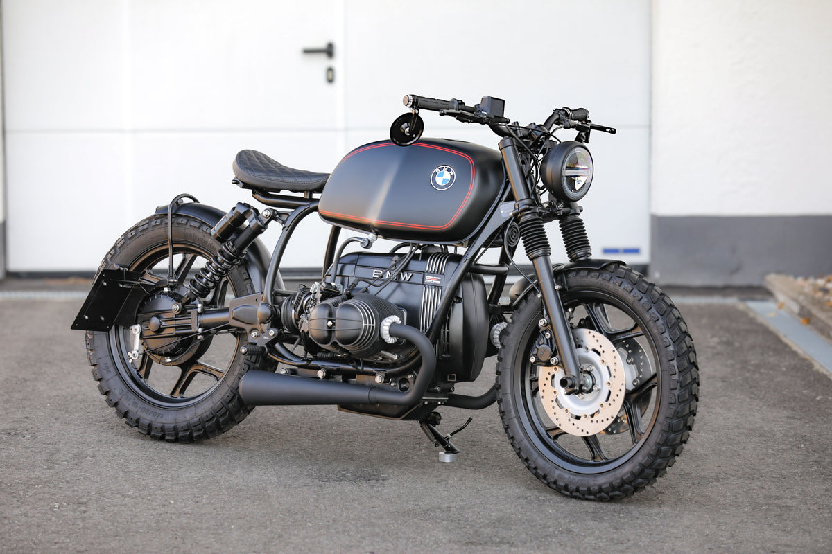 BMW Bobber SE custom bike parked on a concrete surface showcasing its sleek design and craftsmanship.