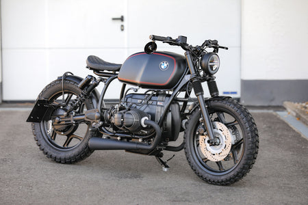 BMW Bobber SE custom bike parked on a concrete surface showcasing its sleek design and craftsmanship.