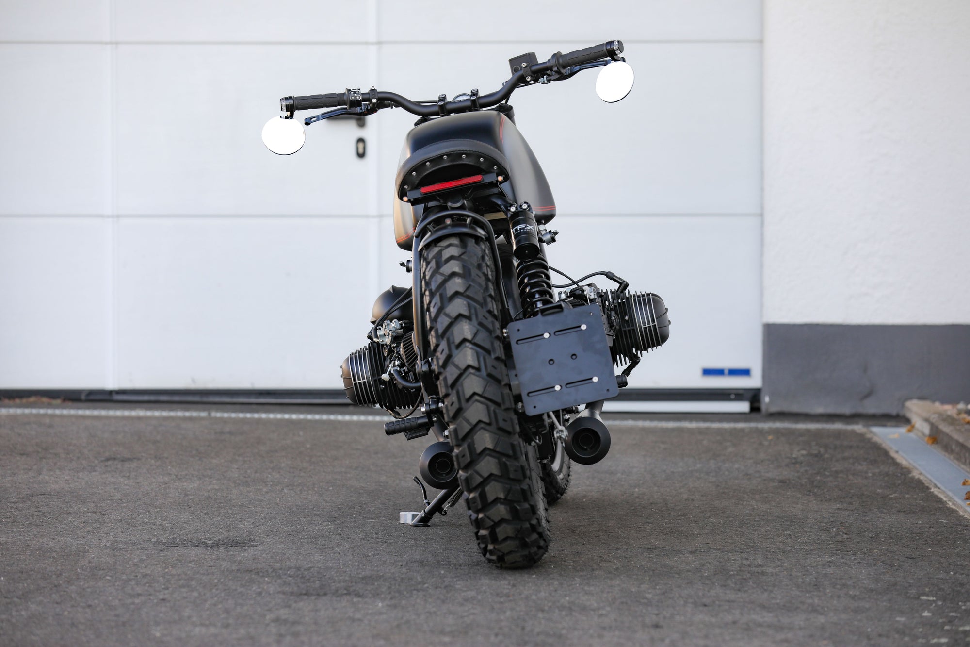 BMW Bobber SE custom bike showcasing a sleek design and powerful silhouette from a rear view.