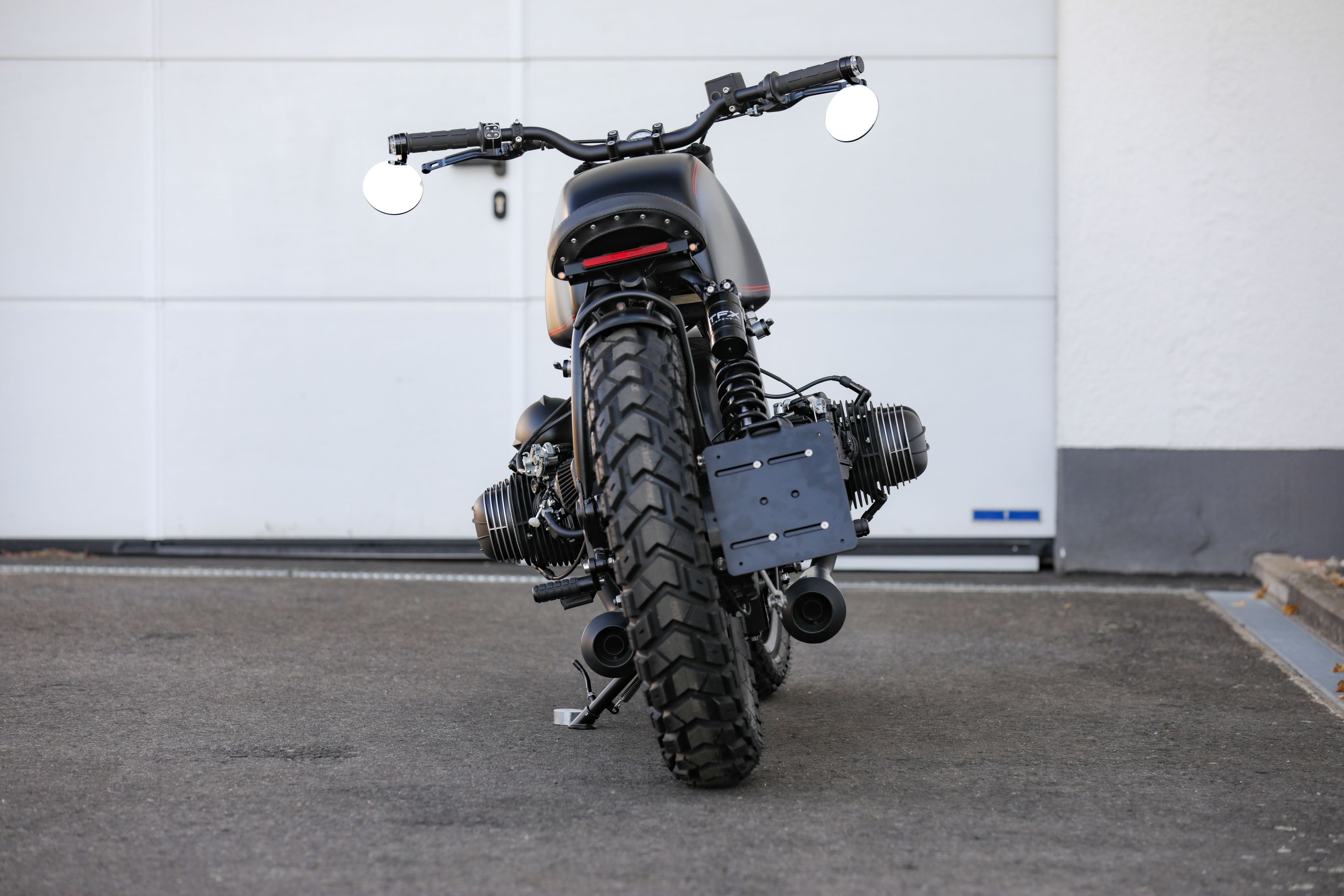BMW Bobber SE custom bike showcasing a sleek design and powerful silhouette from a rear view.