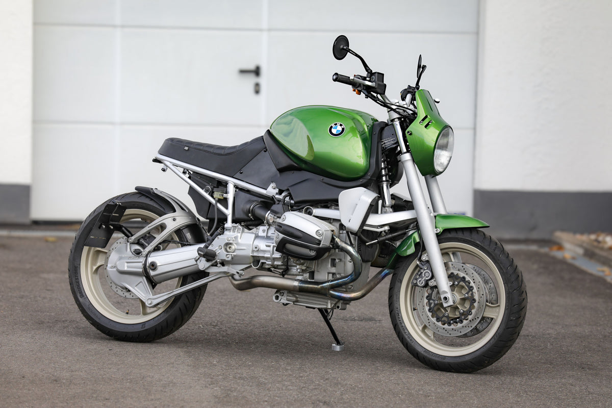 BMW R1100R Telelever motorcycle custom in green color parked beside a wall.