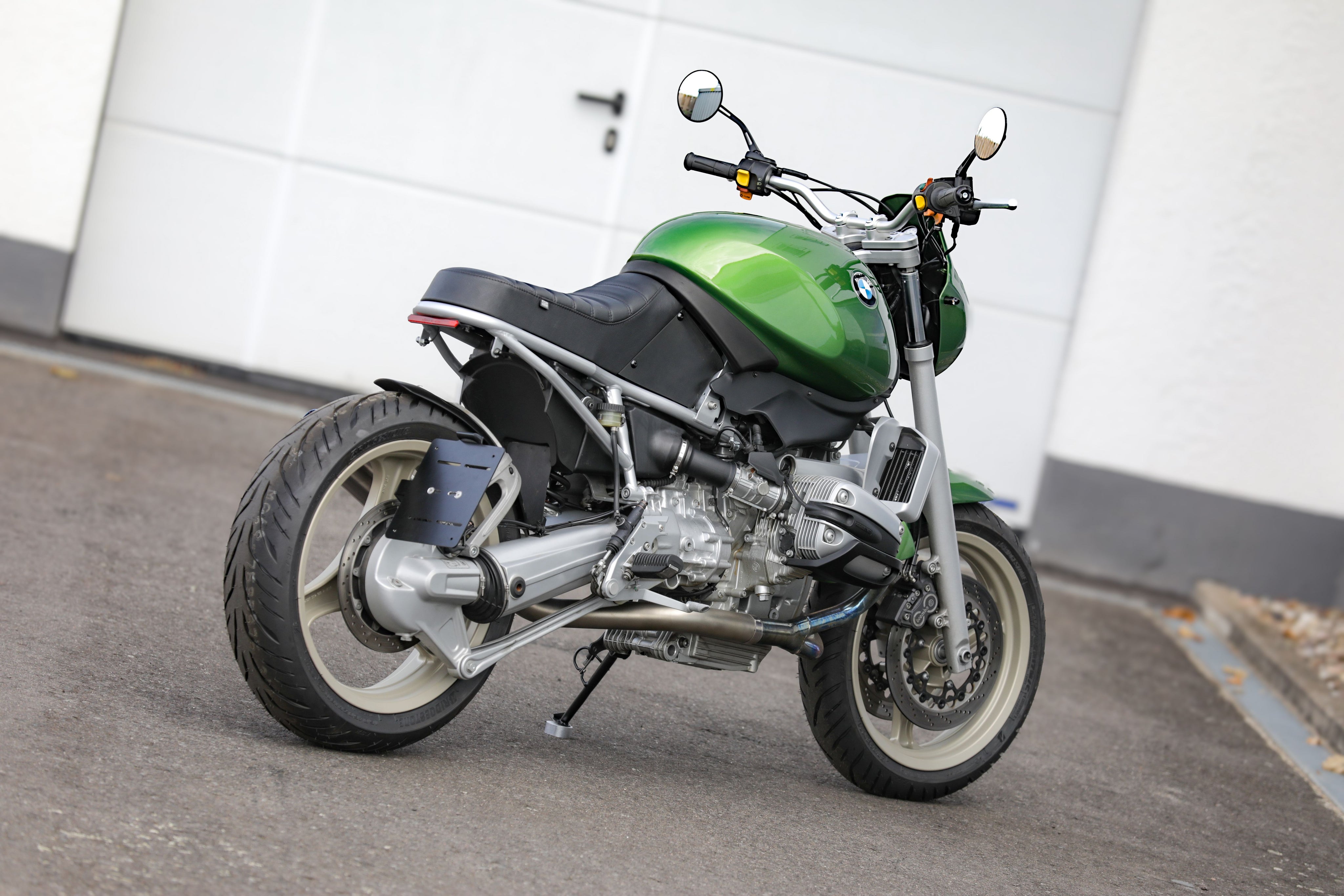 BMW R1100R Telelever motorcycle custom in striking green color parked on pavement.