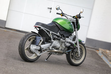 BMW R1100R Telelever motorcycle custom in striking green color parked on pavement.