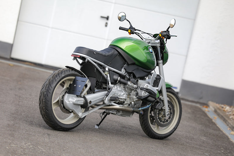 BMW R1100R Telelever motorcycle custom in striking green color parked on pavement.